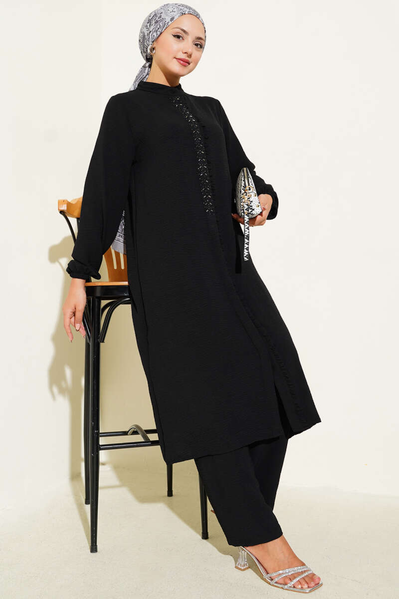 Black Two-piece set with ruffled front and silver stone detail.