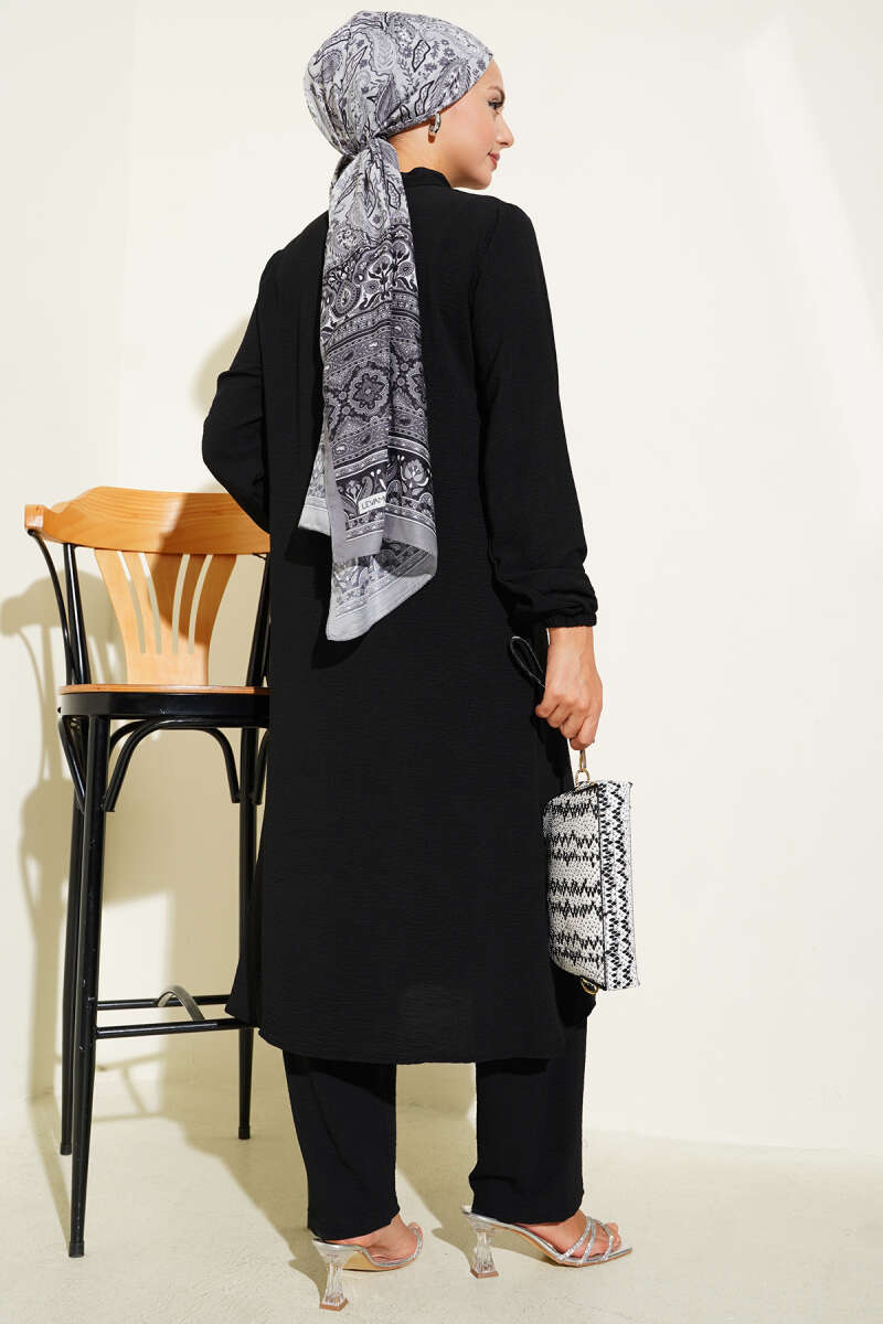 Black Two-piece set with ruffled front and silver stone detail.